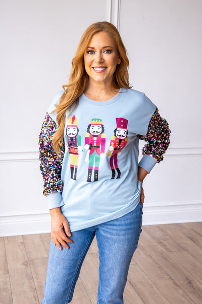 Nutcrackers on Blue Sweatshirt with Sequin Sleeves