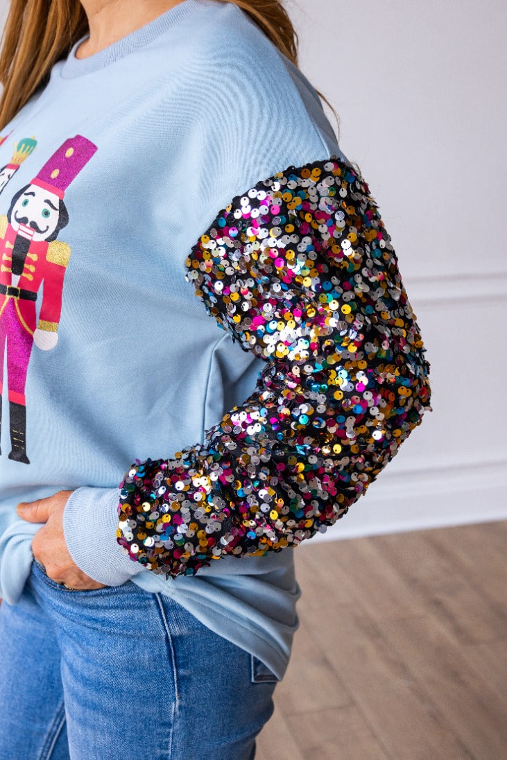 Nutcrackers on Blue Sweatshirt with Sequin Sleeves